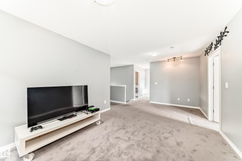 This versatile space features light gray walls, light gray carpet, and white trim - 16720 61 Street, Edmonton, AB - Indoor