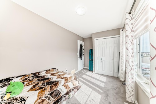 This room features light-colored walls and carpeted flooring, with a window providing natural light - 16720 61 Street, Edmonton, AB - Indoor