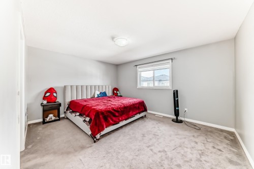 This room features light grey walls and light-colored carpet - 16720 61 Street, Edmonton, AB - Indoor Photo Showing Bedroom