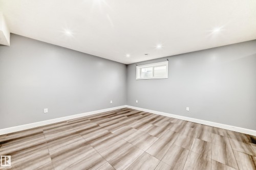 This versatile room features light grey walls, a white ceiling with recessed lighting, and a window providing natural light - 16720 61 Street, Edmonton, AB - Indoor Photo Showing Other Room