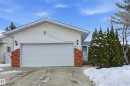 The property features a white exterior with brick accents, a garage, and an inviting front entrance - 85 Arlington Drive, St. Albert, AB  - Outdoor 