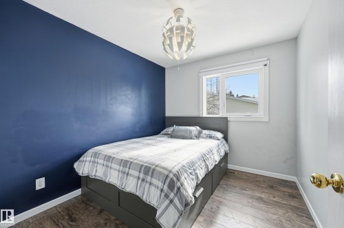 This room features durable plank flooring and a window providing natural light - 85 Arlington Drive, St. Albert, AB - Indoor Photo Showing Bedroom