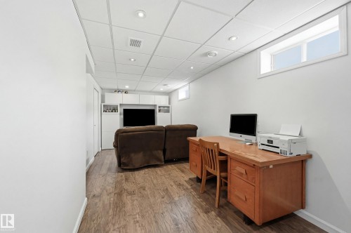 This versatile space features wood-style flooring, recessed lighting, and a drop ceiling - 85 Arlington Drive, St. Albert, AB - Indoor Photo Showing Office