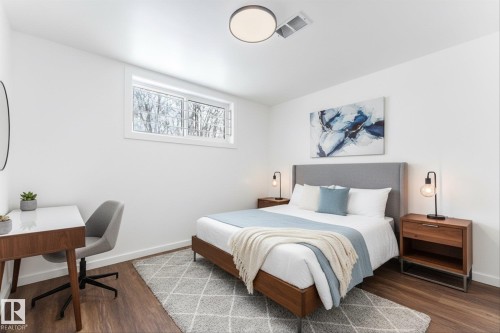 Bedroom featuring hardwood style flooring, a window, and a modern ceiling light fixture - 13116 128A Avenue, Edmonton, AB - Indoor Photo Showing Bedroom