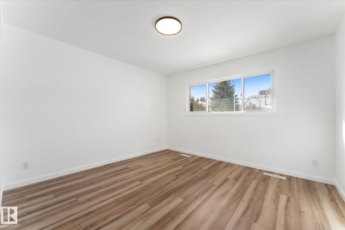Bright room with light wood-style flooring, white walls, and a multi-pane window - 13116 128A Avenue, Edmonton, AB - Indoor Photo Showing Other Room