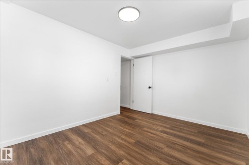 Room featuring hardwood floors, white walls, and a ceiling-mounted light fixture - 13116 128A Avenue, Edmonton, AB - Indoor Photo Showing Other Room