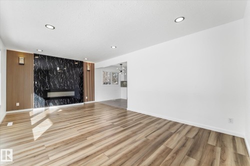 Open concept living area featuring wood-look flooring and recessed lighting - 13116 128A Avenue, Edmonton, AB - Indoor With Fireplace