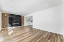 Open concept living area featuring wood-look flooring and recessed lighting - 13116 128A Avenue, Edmonton, AB  - Indoor With Fireplace 