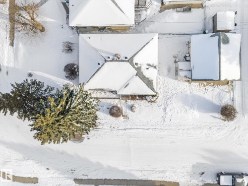Aerial view of the property showing the main building and an additional structure, both featuring snow-covered roofs - 13116 128A Avenue, Edmonton, AB - Outdoor