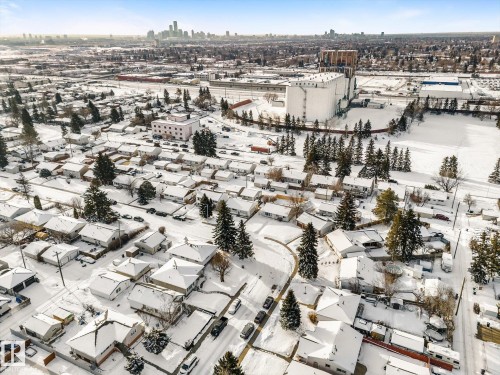 This aerial view highlights the neighborhood's residential properties, all featuring snow-covered rooftops and surrounding grounds - 13116 128A Avenue, Edmonton, AB - Outdoor With View