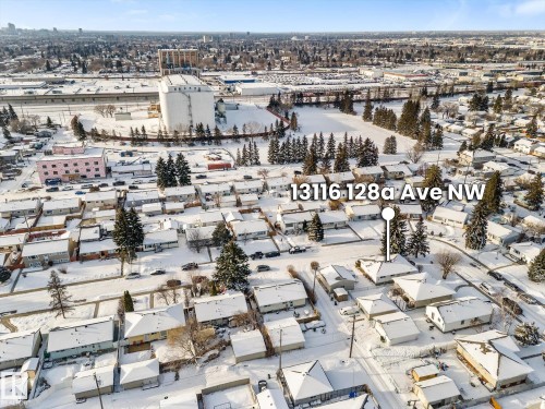 Aerial view of the property and its surrounding neighborhood, featuring a mix of residential structures and mature trees - 13116 128A Avenue, Edmonton, AB - Outdoor With View