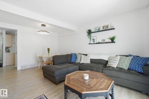 The property features a bright living area with light-toned flooring and white walls, offering a versatile aesthetic - 29 9619 180 Street, Edmonton, AB - Indoor Photo Showing Living Room