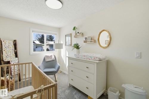 This room features a window providing natural light, light-colored walls, and a textured ceiling - 29 9619 180 Street, Edmonton, AB - Indoor