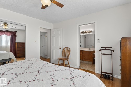 This bedroom features light hardwood flooring and a ceiling fan with integrated lighting - 22 Riverpointe, Fort Saskatchewan, AB - Indoor Photo Showing Bedroom