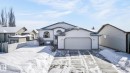 The property features a white exterior, an attached garage, and a paved driveway - 22 Riverpointe, Fort Saskatchewan, AB  - Outdoor 