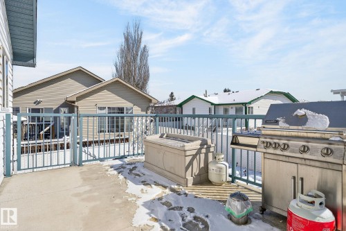 The property features a concrete patio with a protective railing - 22 Riverpointe, Fort Saskatchewan, AB - Outdoor