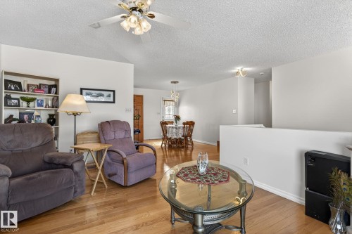 The living area features hardwood flooring and a ceiling fan - 22 Riverpointe, Fort Saskatchewan, AB - Indoor Photo Showing Living Room