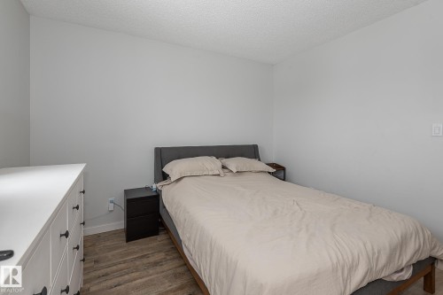 This room features light-colored walls and wood-look flooring, providing a neutral canvas - 8326 157 Avenue, Edmonton, AB - Indoor Photo Showing Bedroom