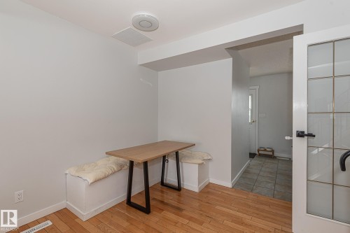 Dining area featuring hardwood floors and a built-in bench with cushions - 8326 157 Avenue, Edmonton, AB - Indoor