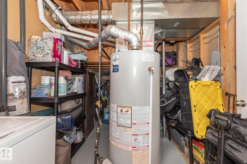 Utility area featuring a water heater and exposed ductwork - 8326 157 Avenue, Edmonton, AB - Indoor Photo Showing Basement