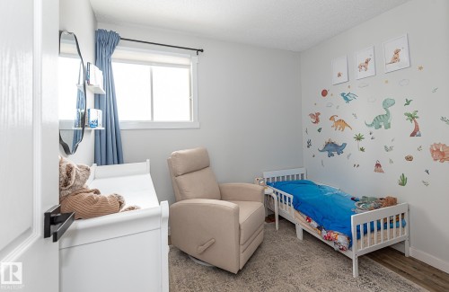 This room features a window providing natural light, light-colored walls, and a light-toned rug - 8326 157 Avenue, Edmonton, AB - Indoor Photo Showing Bedroom