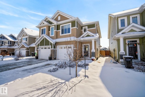 This property features an inviting exterior with a two-car garage, contrasting siding colors, and a covered front entryway - 8225 24 Avenue, Edmonton, AB - Outdoor With Facade