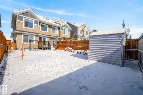 The property features a fenced yard, a rear deck, and a shed - 8225 24 Avenue, Edmonton, AB - Outdoor