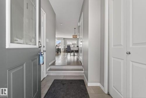 Inviting entry with tile flooring, gray walls, and white trim - 8225 24 Avenue, Edmonton, AB - Indoor Photo Showing Other Room