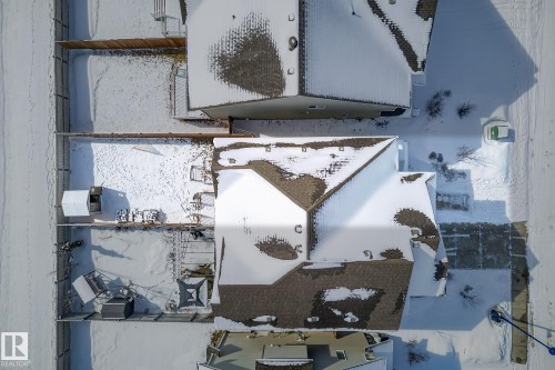 The property features a brown shingle roof and a paved driveway - 8225 24 Avenue, Edmonton, AB - Outdoor