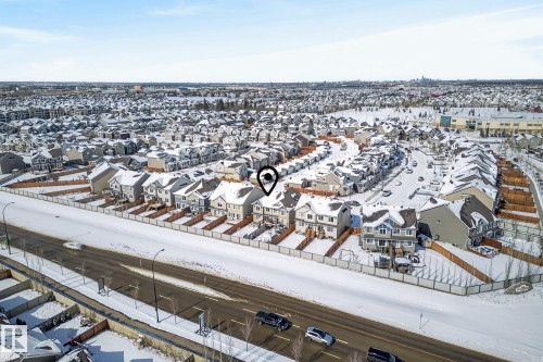 Aerial view of the property and its surrounding neighbourhood, featuring a paved road, residential homes, and snow-covered terrain - 8225 24 Avenue, Edmonton, AB - Outdoor With View