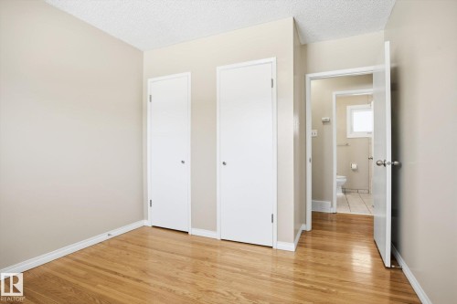 This room features hardwood floors and two white doors - 6 Garden Crescent, St. Albert, AB - Indoor Photo Showing Other Room