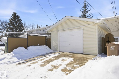 The property includes a detached garage with a white garage door and light-colored siding - 6 Garden Crescent, St. Albert, AB - Outdoor With Exterior