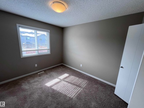 The property features a carpeted staircase with a handrail, leading to a carpeted landing - 1421 26 Avenue, Edmonton, AB - Indoor Photo Showing Other Room