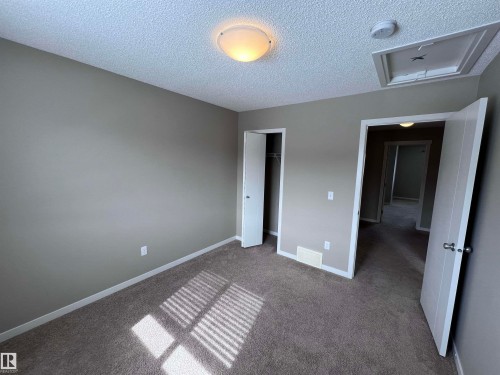 Room with textured ceiling, a flush mount light fixture, and a window with blinds - 1421 26 Avenue, Edmonton, AB - Indoor Photo Showing Other Room