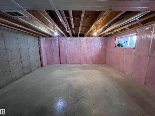 Kitchen featuring a stainless steel French door refrigerator, dark wood flooring, and a white interior door - 1421 26 Avenue, Edmonton, AB - Indoor Photo Showing Basement