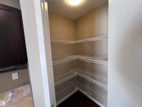 The property features a practical pantry with wire shelving, offering efficient storage solutions - 1421 26 Avenue, Edmonton, AB - Indoor With Storage