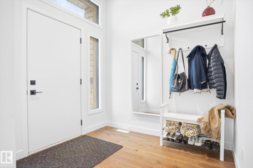 Entryway featuring a white door with black hardware, flanked by a vertical window and an overhead transom window - 9821 85 Avenue, Edmonton, AB - Indoor Photo Showing Other Room