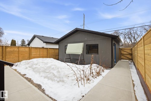 The property features a detached corrugated metal building with a dark roof and a window - 9821 85 Avenue, Edmonton, AB - Outdoor With Exterior