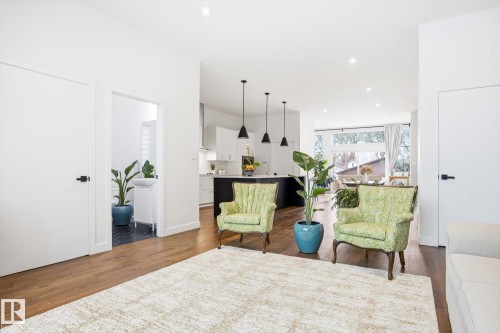 The property features an open-concept living space with hardwood floors and recessed lighting - 9821 85 Avenue, Edmonton, AB - Indoor Photo Showing Living Room