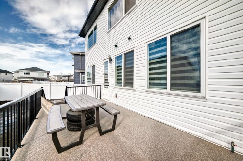 This property features a paved patio area with black railings, providing outdoor living space - 15108 11 Street, Edmonton, AB - Outdoor With Exterior