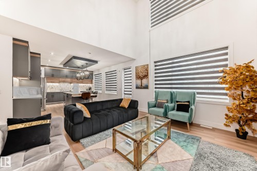 The property features an open concept living area with high ceilings, hardwood flooring, and large windows with horizontal blinds - 15108 11 Street, Edmonton, AB - 
