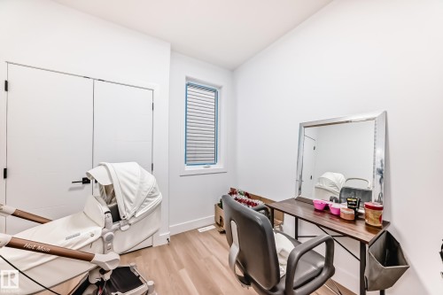 This room features light wood flooring, white walls, and a window with horizontal blinds - 15108 11 Street, Edmonton, AB - Indoor Photo Showing Office