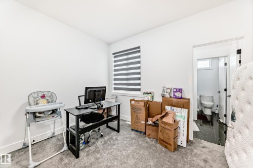 This room features a window with horizontal blinds, light-colored carpeting, and white walls - 15108 11 Street, Edmonton, AB - Indoor Photo Showing Office
