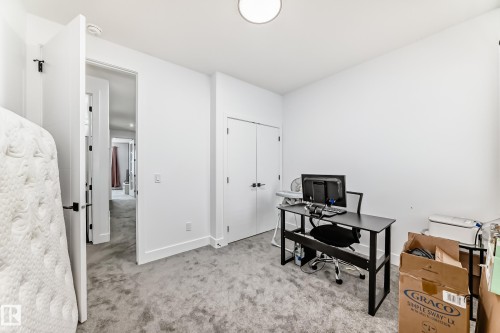 This room features light grey carpet flooring and white walls - 15108 11 Street, Edmonton, AB - Indoor Photo Showing Office