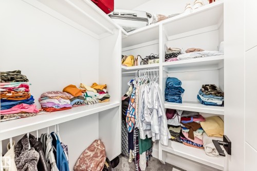 The property includes a well-organized closet space featuring white shelving units and hanging rods - 15108 11 Street, Edmonton, AB - Indoor With Storage