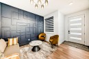 The room features a decorative wall paneling in a geometric pattern, light wood flooring, and a modern light fixture on the ceiling - 15108 11 Street, Edmonton, AB  - Indoor 