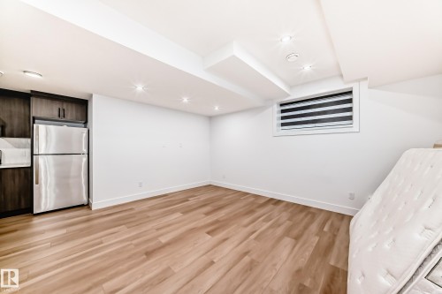 The property features durable flooring, recessed lighting, and a window with horizontal blinds - 15108 11 Street, Edmonton, AB - Indoor