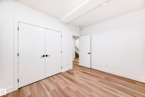 The room features light wood-style flooring, white walls, and a white ceiling - 15108 11 Street, Edmonton, AB - Indoor Photo Showing Other Room