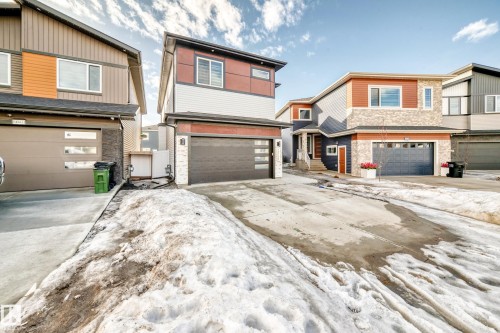 The property features a two-story exterior with a combination of light-colored siding and orange horizontal accents - 15108 11 Street, Edmonton, AB - Outdoor With Facade