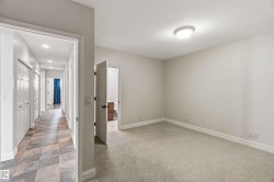 This bedroom features light-colored walls and carpeting, creating a bright atmosphere - 